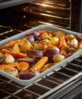 Ceramic Nonstick Baking Sheet For Oven Cookin 15x10 Inches Durable Aluminum Tray With PTFE And PFOA Free Coating in oven with roasted vegetables