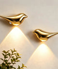 Super Sleek Bird Motion Sensor Wall Light With Heavy Duty Rechargeable Battery 2 Pack Zero Hassle USB Setup Works Like A Charm For Closets And Hallways All Year Round, gold finish, mounted on wall.