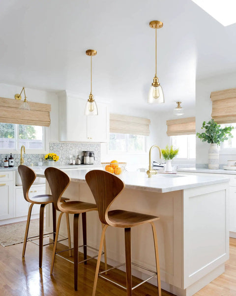 Gold Pendant Lights For Kitchen Island Three-Pack With Mini Bell Glass Shades hanging above a white countertop