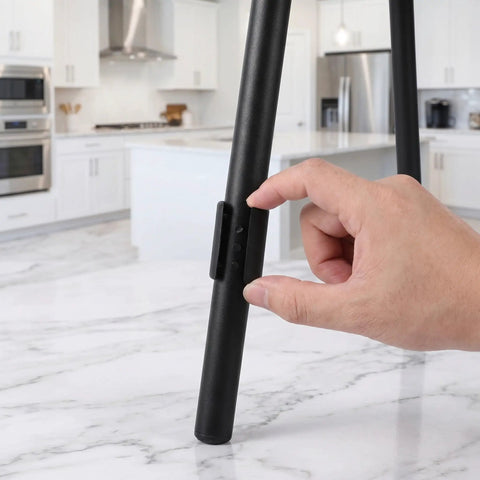Hand installing U Shaped Floor Glides For Sled Base Chairs 20 Pack, Plastic Chair Pads, Black, on metal tube frame in kitchen