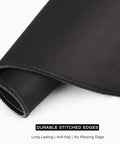 Close-up of black mouse pad showing durable stitched edges, a feature of the Beach Theme Mouse Pad 12x10 Inch For Desk Setup Waterproof Non Slip Rubber.