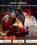 Family using Outdoor Smart Dimmer Plug With Alexa And Google Home Control to dim Christmas lights by tree