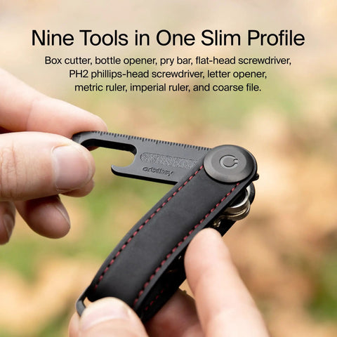 Hands holding Ultra Slim Stainless Steel Multi Tool V2 With Titanium Coating Pocket EDC Gear for bottle opener and package cutter.