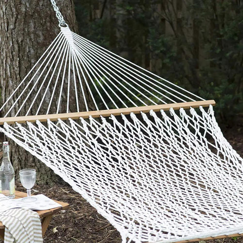 Heavy Duty Nylon Rope Seven Eighths Inch By One Hundred Feet White Rope For Anchoring, Tree Work, Cargo Hauling, DIY Projects And Outdoor Use, UV Moisture And Abrasion Resistant Cord Built Tough in a woven hammock displayed outdoors.