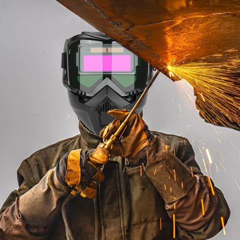 Welder using Auto Darkening Pro Grade Welder Helmet With Detachable Shield And Full Face Protection, sparks flying