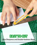 TIFICAL 9mm snap-off utility knife cutting white paper on green cutting mat (front view)