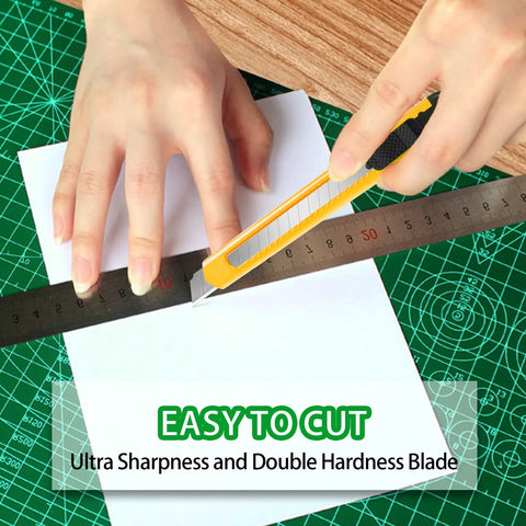 TIFICAL 9mm snap-off utility knife cutting white paper on green cutting mat (front view)
