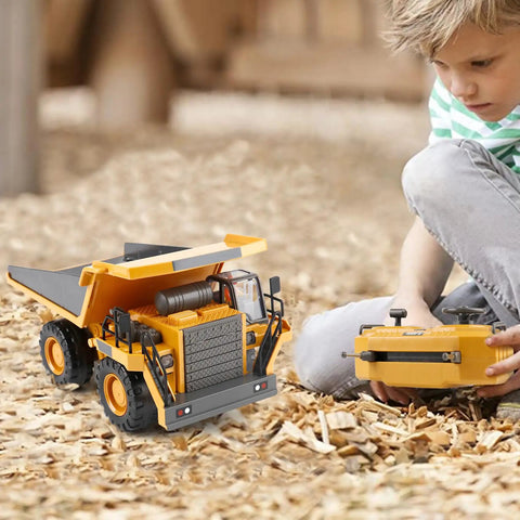 Child playing with remote control dump truck toy with metal bed and lights, real tilting dump bed, outdoor durable construction vehicle