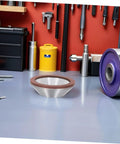 Diamond Cup Grinding Wheel Perfect For Metal And Stone Sharpening Tasks. Heavy duty abrasive disc on a workshop table.