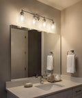 Winslow 30 Inch Vanity Light In Brushed Nickel Four Light Clear Seeded Glass Bath Fixture illuminating a modern bathroom.