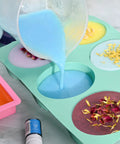 All In One Soap Making Kit For Adults And Teens With Shea Butter Glycerin Melt And Pour Bases shown with colored soap molds and dried petals.