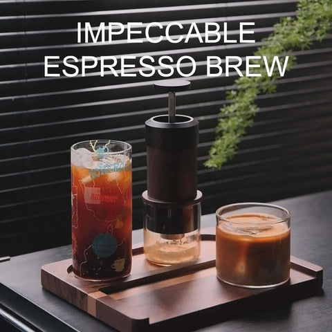 Manual Espresso Maker For On The Go Portable Coffee Machine With 2 In 1 Bottomless Portafilter next to iced coffee on tray