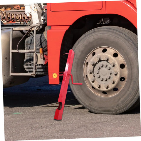 Manual Strap Winder For Trucks beside a truck wheel, showing the hand crank and red steel design for cargo belt winding.
