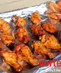 Chicken wings being cooked using Medium Size Indirect Direct Heat Grill Accessory for Charcoal Grills Stainless Steel Fits Weber Kettle 22.5 26.5 Smokey Mountain XL Kamado XL and Big Green Egg For Low And Slow Smoking Or High Direct Grilling