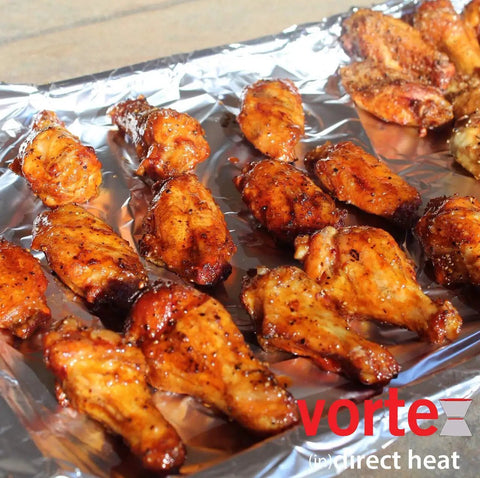 Chicken wings being cooked using Medium Size Indirect Direct Heat Grill Accessory for Charcoal Grills Stainless Steel Fits Weber Kettle 22.5 26.5 Smokey Mountain XL Kamado XL and Big Green Egg For Low And Slow Smoking Or High Direct Grilling