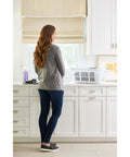 Woman in kitchen with XL Hip Hugger Laundry Basket 2.1 Bushel White With Royal Blue Handles on counter