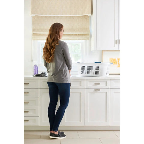 Woman in kitchen with XL Hip Hugger Laundry Basket 2.1 Bushel White With Royal Blue Handles on counter