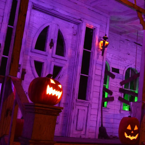 Haunted porch with pumpkins lit by Dope 66ft Black Light LED Strip Kit With 1200 LEDs 385nm-400nm UV Range 12V Flexible Indoor UV Tape
