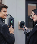 Two people using the Go-To Portable Level 2 EV Charger With 40 Amp Output, 25ft Cable, 120V To 240V NEMA 14-50, Outdoor EVSE With LED Display.