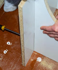 Installation of White Furniture Shelf Support Pegs Cam Lock Fasteners With Cabinet Connectors For Hidden Shelf Brackets.