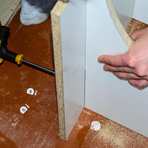 Installation of White Furniture Shelf Support Pegs Cam Lock Fasteners With Cabinet Connectors For Hidden Shelf Brackets.