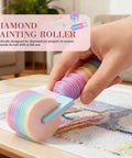 Detachable Roller Tool With Ergonomic Grip For Painting Projects No Sweat Smooth Operator Rolling Accessory Effortless Cleanup. Multi-colored roller in use for diamond painting on canvas.