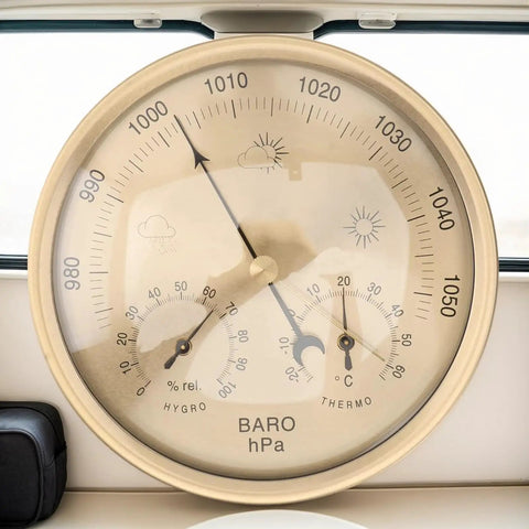 Close-up of All In One Indoor Outdoor Barometer Thermometer Hygrometer Weather Station showing air pressure and temperature gauge.