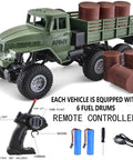 One Sixteenth Scale 6x6 RC Military Truck Off Road Toy Car 4WD All Terrain Army Transport Vehicle With Real Rubber Tires And Front LED Lights A Dope Gift For Kids Boys And Teens, showing army truck model with controller and six fuel drums