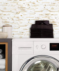 Laundry room with Peel And Stick Backsplash Tiles Marble Calacatta With Metal Gold Finish behind a white washing machine.