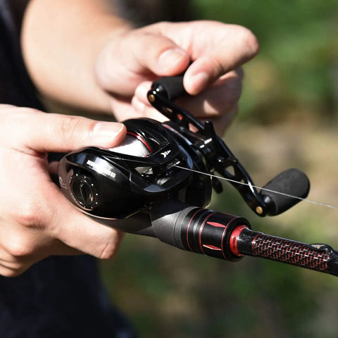 Person holding Royale Legend II Baitcasting Reel with Compact Low Profile Design 17.64 LB Carbon Drag for Freshwater Fishing