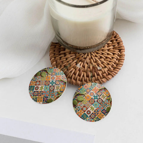 Fresh Grid Print Dangle Earrings for Women Lightweight Silver Plated Faux Leather Statement Drops With Hypoallergenic Rust Proof Hooks Slaying Casual Daily Looks All Day Long on a table with a candle.