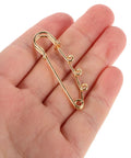 Premium 20 Pack Of Versatile Loop Safety Pin Brooches To Clasp Sweaters Scarves And Denim Belts While Adding Instant Chic Vibes To Everyday Streetwear And Casual Fits, shown in hand.