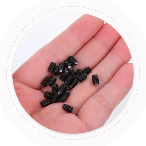 Slick Stainless Steel Hex Ball Plunger Screw Set For Cabinet Doors in a hand, showcasing durable black stainless screws.