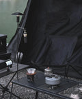 Collapsible Lantern Stand For Camping And Backyard with aluminum hook, ground stakes and lantern, next to camping setup.