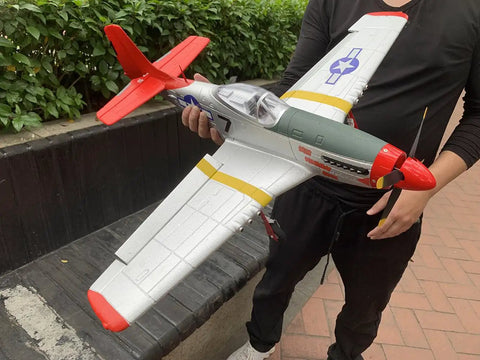 Person holding an Extra Large 29.5 Inch P51 Mustang Remote Control Combat Aircraft 4CH Brushless RC Plane With Dual Batteries