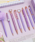 Purple Crystal Diamond Pens Set 8 Metal Pens In Different Styles With Black And Blue Ink For Journaling And Office Use For Women Glam Back To School Essentials And Girl Birthday Gift Idea displayed on pink background.