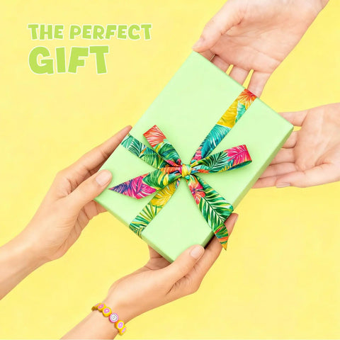 Hands exchanging a green gift box with colorful ribbon, featuring a bracelet from the Colorful Fruit Polymer Clay Beads Bracelet Making Kit.