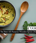 13.5 Inch Teak Cooking Spoon Wooden Mixing Spoon alongside a dish, herbs, and spices