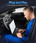 Mechanic using laptop with Bluetooth OBD2 Scanner For iPhone iOS Android Windows Car Code Reader in vehicle.