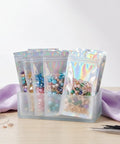 100 Pack Holographic Jewelry Bags With Clear Window Resealable Self Sealing Packaging for jewelry display on table