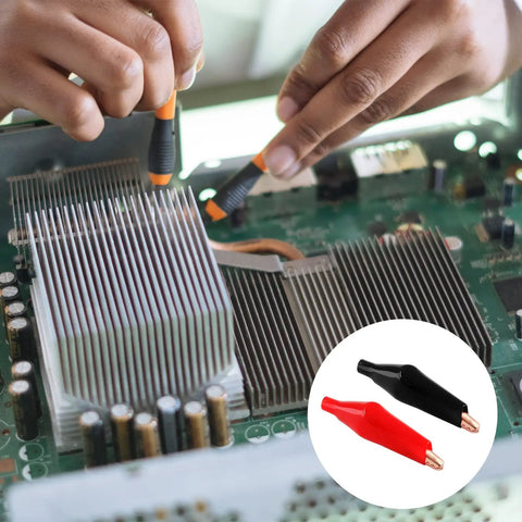Person using Insulated Copper Gator Clips 24 Pack for Electrical Testing Red and Black Crocodile Clamps on circuit board.
