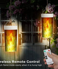 Hanging flameless LED flame lights with remote control in a garden setting, showing realistic dancing flames.
