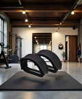 One Pair Black Bike Pedal Straps With Adhesive For Fixed Gear And Regular Bicycles placed on a mat in a gym setting.