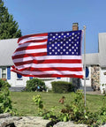 All American Patriotic 3x5 Ft Outdoor Flag With Brass Grommets displayed in garden, durable polyester for home decor