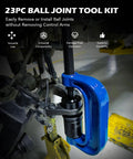 Blue C-frame ball joint press tool mounted on car suspension for joint removal