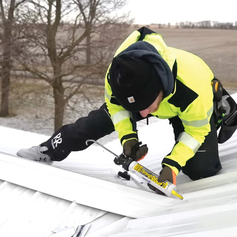 Person applying All Weather Clear Roof Sealant 10.5 Oz Cartridge Pack Of Twelve Waterproof Leak Stopper on metal roof.