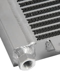 Heavy Duty Transmission Oil Cooler For Trucks And Vans Up To 40K GVW With Low Pressure Drop Direct Fit Upgrade Your Ride Today. Brazed aluminum cooler close-up, threaded fitting and fins