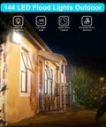 LED Flood Lights Outdoor 100W 10000LM Plug In IP66 Waterproof 6000K lighting a house at night, showcasing brightness