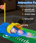 Dinosaur Themed Kids Golf Set For Ages 3 To 6 With Automatic Ball Returner Light Up Balls Indoor Outdoor Putting Mat Toddler Golf Clubs Super Fun Birthday Gift For Boys And Girls showing dinosaur automatic ball returner and light-up balls