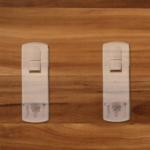 50 Pack White Plastic Shelf Support Pegs For Cabinets And Living Room Shelves on wooden background, showing sturdy design